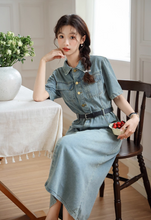 画像をギャラリービューアに読み込む, パリ郊外のアパルトマンで果実をかじる少女のデニムワンピース_K0147