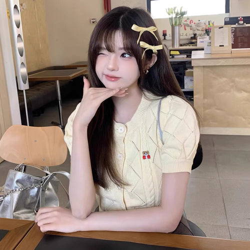 カフェの窓辺でパンプキンラテを飲む少女のガーリーカーディガン_K0196