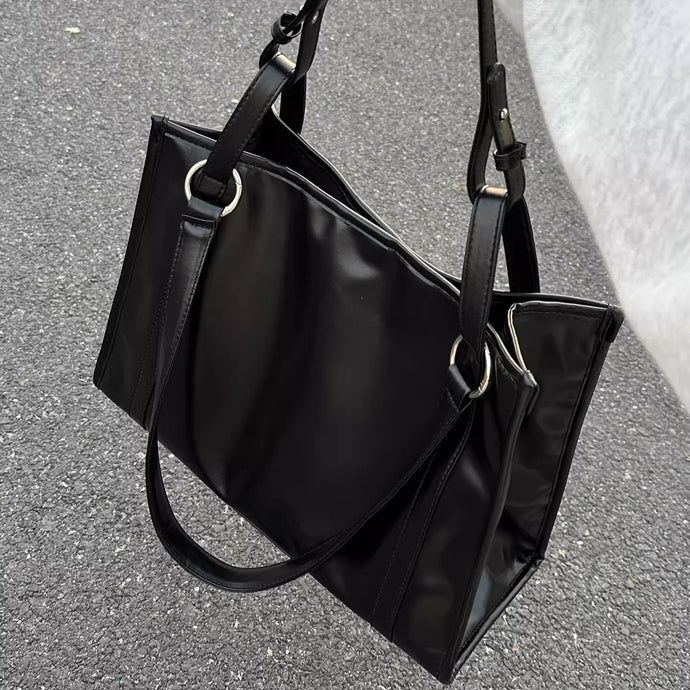 都会の雑踏を抜けてカフェに立ち寄る女のシックレザートート_K0179